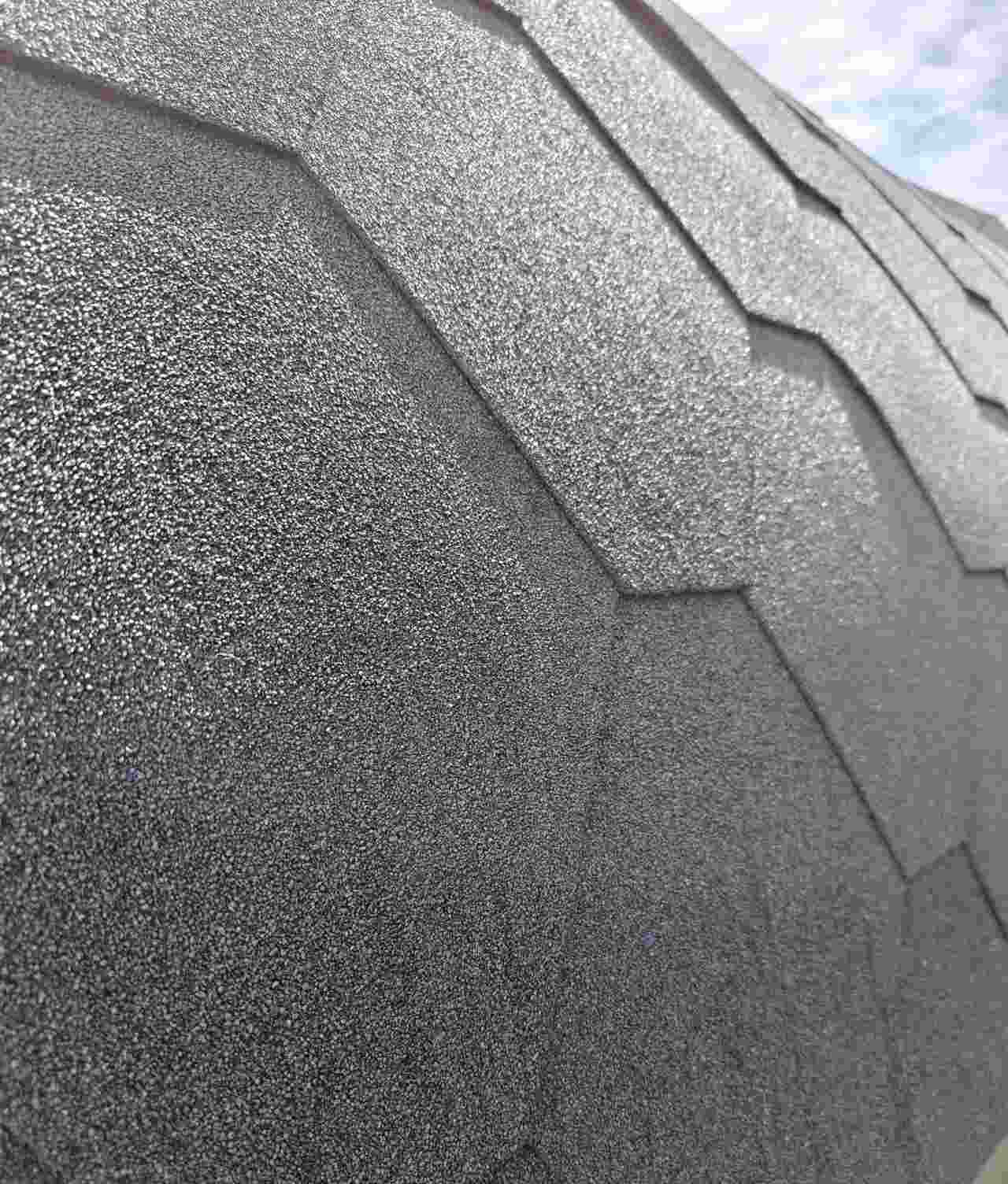 A close-up view of premium black bitumen roofing shingles on a Terra Sauna build in Guernsey, highlighting the durable, weather-resistant granular texture and hexagonal overlapping pattern.